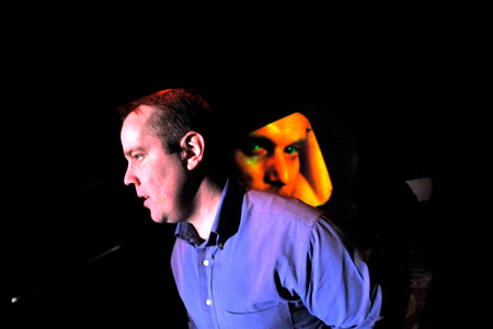 Armin, (Eric Leonard), in conversation with his virtual lover Jorg, (Tony Lewis).