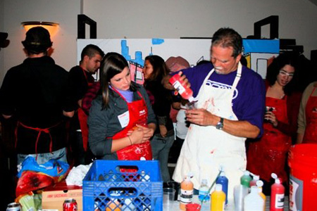 Muralist Gamaliel Ramirez creating a Mango Street mural with the teens in attendance.