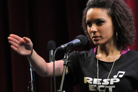 A poet performs her piece for the crowd.