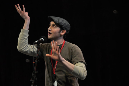 A poet acts out his original poem for the judges.