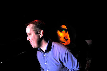 Armin, (Eric Leonard), in conversation with his virtual lover Jorg, (Tony Lewis).
