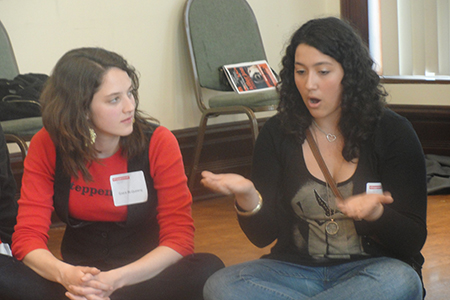 Young Adult Council member Grace McQueeny listens to a guest speak about the play