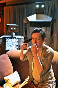 Jane Gordon (Nina O'Keefe) is watched attentively by robots Billy and Hans (controlled by operators Bruce Phillips and Lea Pascal)