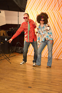 Guests take advantage of the photo station, complete with 70s costume pieces