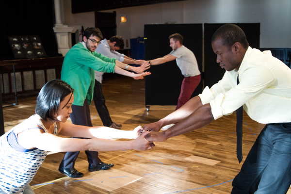 The cast warms up with choreographer Frankie DiCiaccio