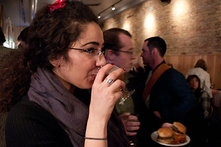 A guest enjoying EXPLORE with a beer at Burger Bar Chicago