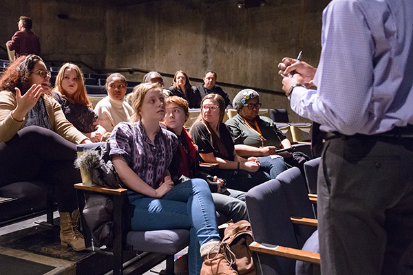 Audience members discuss with a facilitator