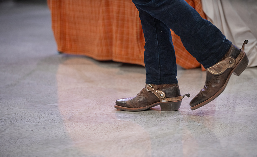 A close-up image of the cowboy boots with spurs, worn by Nick.