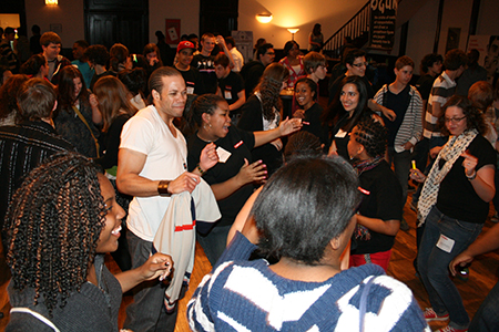 Kiplan Dooley (Elegba/Marcus) dances with a room packed with teenagers.
